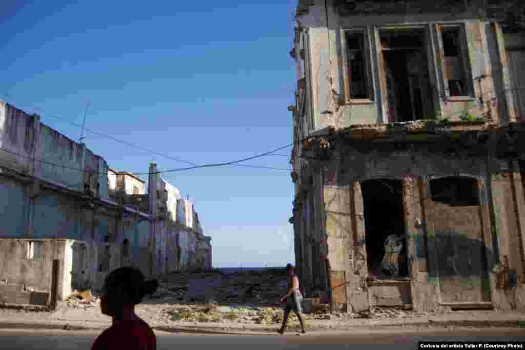 Obra del artista cubano Yulier P. El grafitero aprovecha las ruinas de los derrumbes, para insertar sus piezas en el espacio urbano.