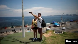 Turistas se fotografían en el Malecón el 21 de agosto de 2019. REUTERS/Fernando Medina