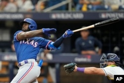 Texas Rangers' Adolis Garcia bats against the Tampa Bay Rays during Game 1 in an AL wild-card baseball playoff series, Tuesday, Oct. 3, 2023, in St. Petersburg, Fla. (AP Photo/John Raoux)