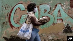 Una mujer carga un cartón de huevos por una calle de La Habana. (AP/Ramon Espinosa)