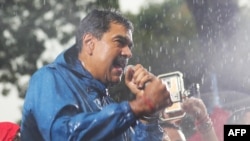 Handout picture released by Venezuelan Presidency shows Venezuelan President Nicolas Maduro delivering a speech to supporters during a rally at the Miraflores presidential palace in Caracas on August 5, 2024.