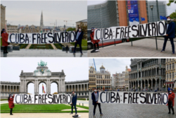 Activista cubanoamericano residente en Bélgica Léo Juvier-Hendrickx posa con un cartel exigiendo libertad de Silverio Portal. Foto cortesía