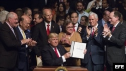 El presidente estadounidense, Donald J. Trump, firma el memorando presidencial sobre la política con Cuba tras finalizar su discurso en el teatro Manuel Artime de la Pequeña Habana, en Miami.