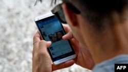 Un joven se conecta a Internet desde su teléfono en La Habana. (YAMIL LAGE / AFP)