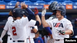 Nicke Allen (12) celebra con el segunda base Eddy Alvarez (2) después de conectar un jonrón en la cuarta entrada del juego contra Puerto Rico. (Sam Navarro-USA TODAY Sports)